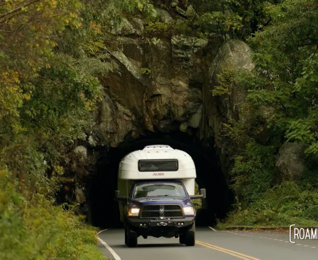 Vintage 1970 Avion C11 truck camper driving through a tunnel in Shenandoah National Park.