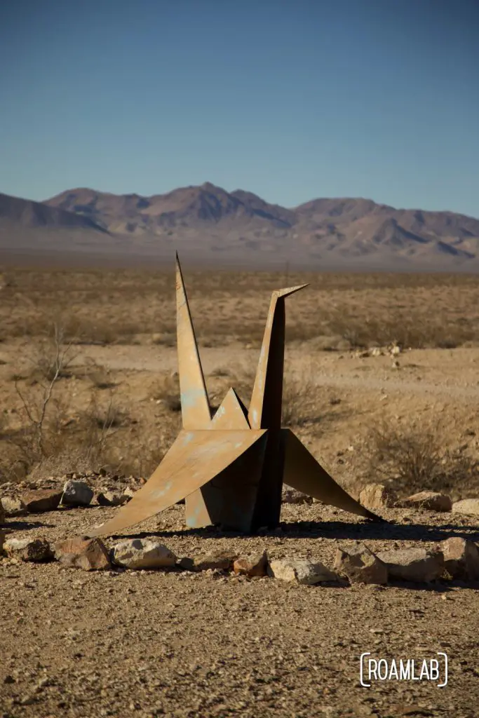 Giant origami crane composed of folded sheet metal located in the Nevada desert.