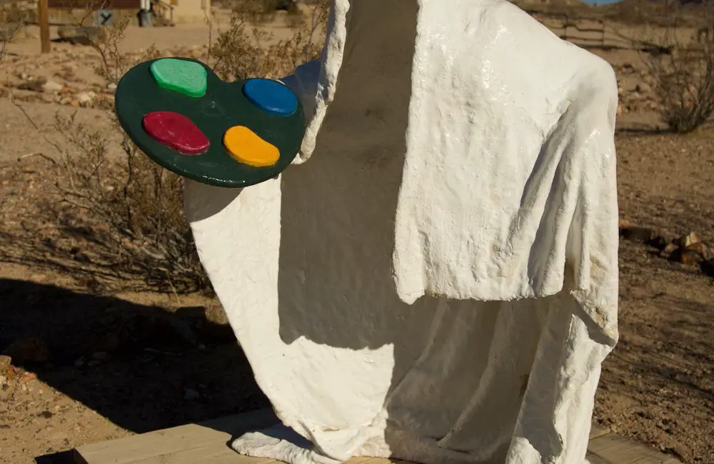 Sculpture of a ghost holding an artist's palette at a Goldwell Open Air Museum.