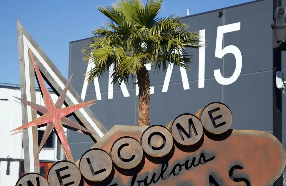 Dystopian "Welcome to Fabulous Las Vegas Nevada" sign rusting on its side in front of Area 15.