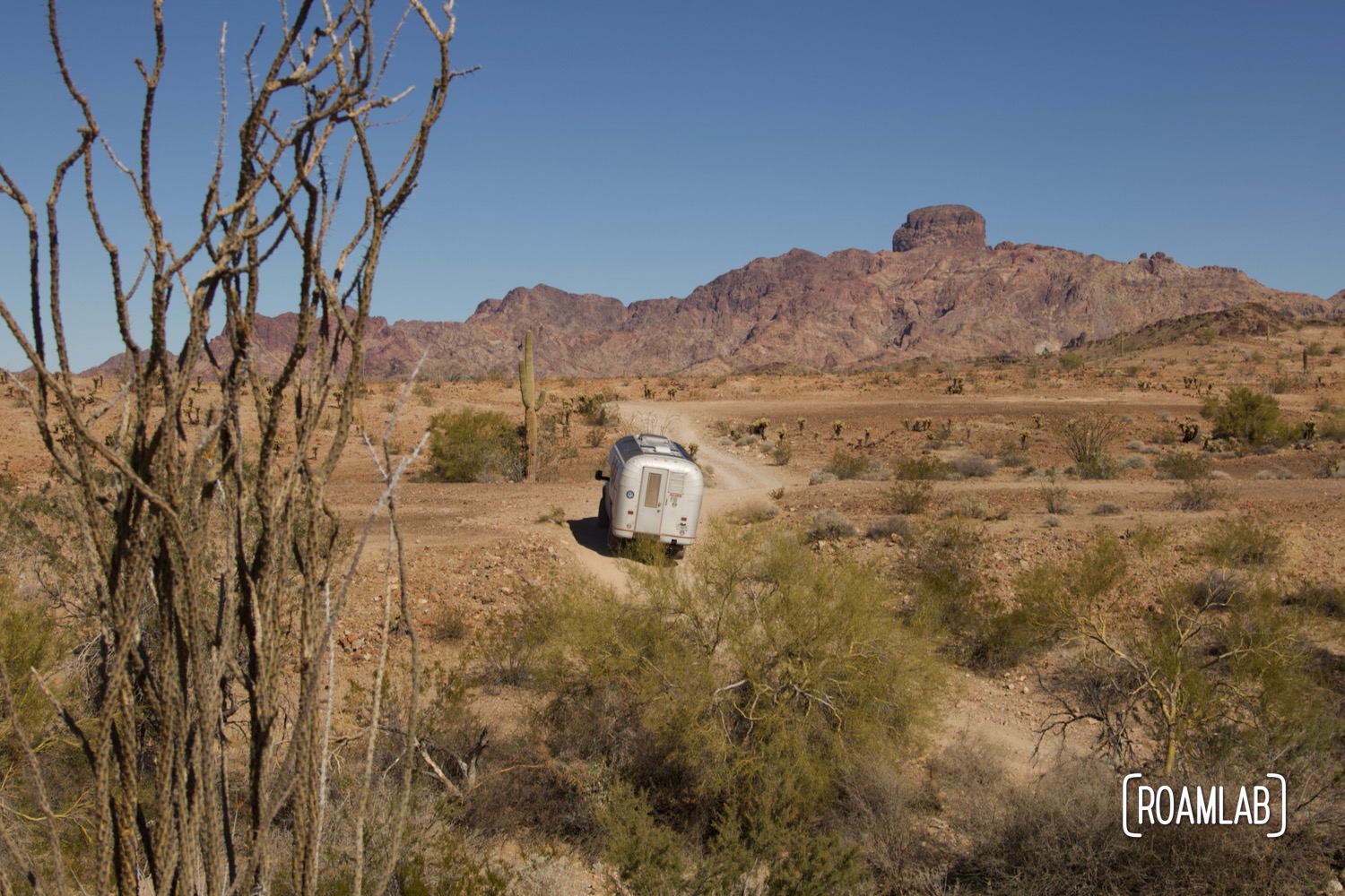 Avion C11 truck camper navigating a rocky dirt Castle Dome Mine Road in Kofa Wilderness Refuge.