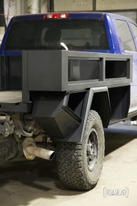Closeup of partially constructed black truck bed.
