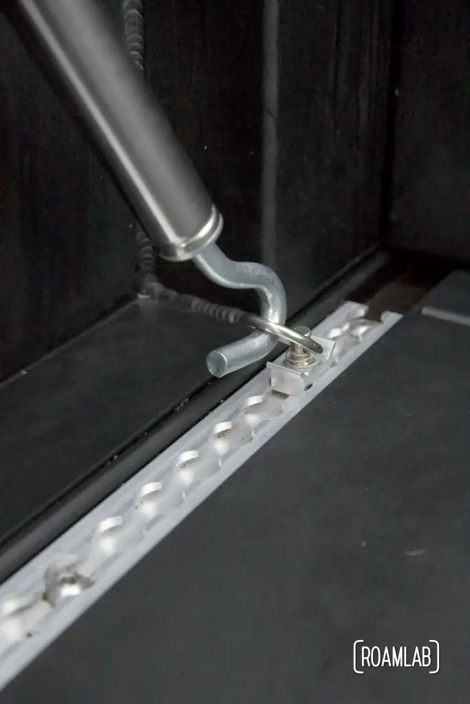 Turnbuckle hooked into an L-track using an o-ring.
