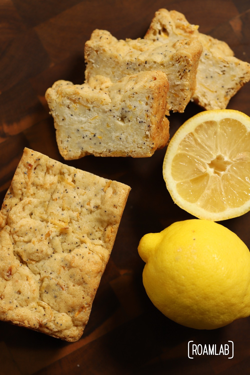 Lemon Poppyseed Squash Bread on a cutting board with lemons.