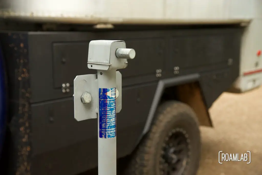 Closeup of truck camper jack cleaned and coated with zinc galvanizing compound spray in front of a truck camper.