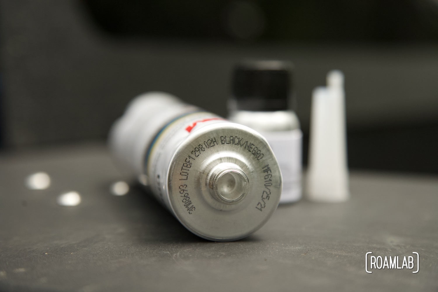 Side view of a urethane bottle exposing printed message "black"