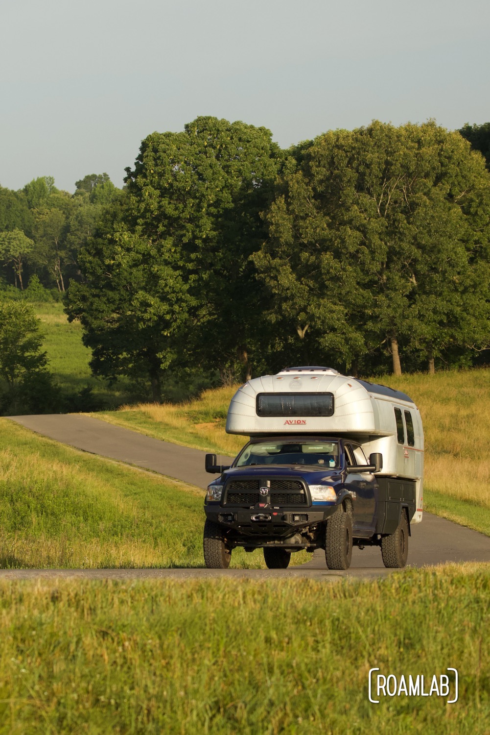 1970 Avion C11 truck camper driving along the Elk & Bison Prairie loop road in Land Between the Lakes.