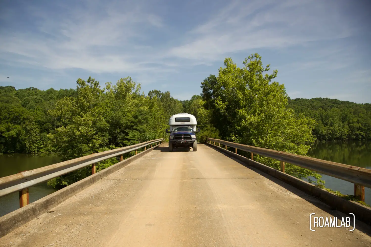 Avion C11 truck camper crossing a cement bridge.