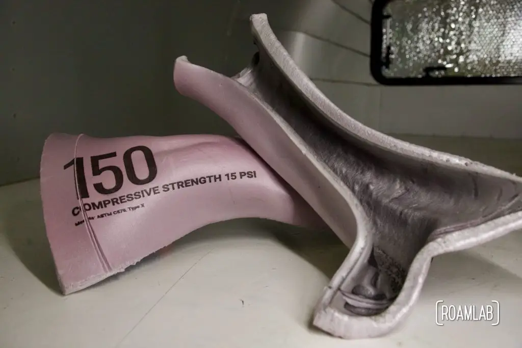 Two pieces of pink insulation board warped by heat.