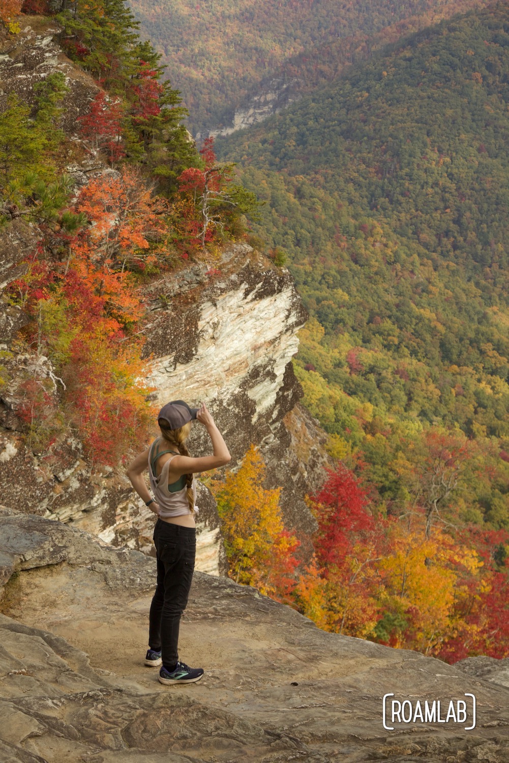 Woman looking out over the fall colors of Linville Gorge Wilderness Area