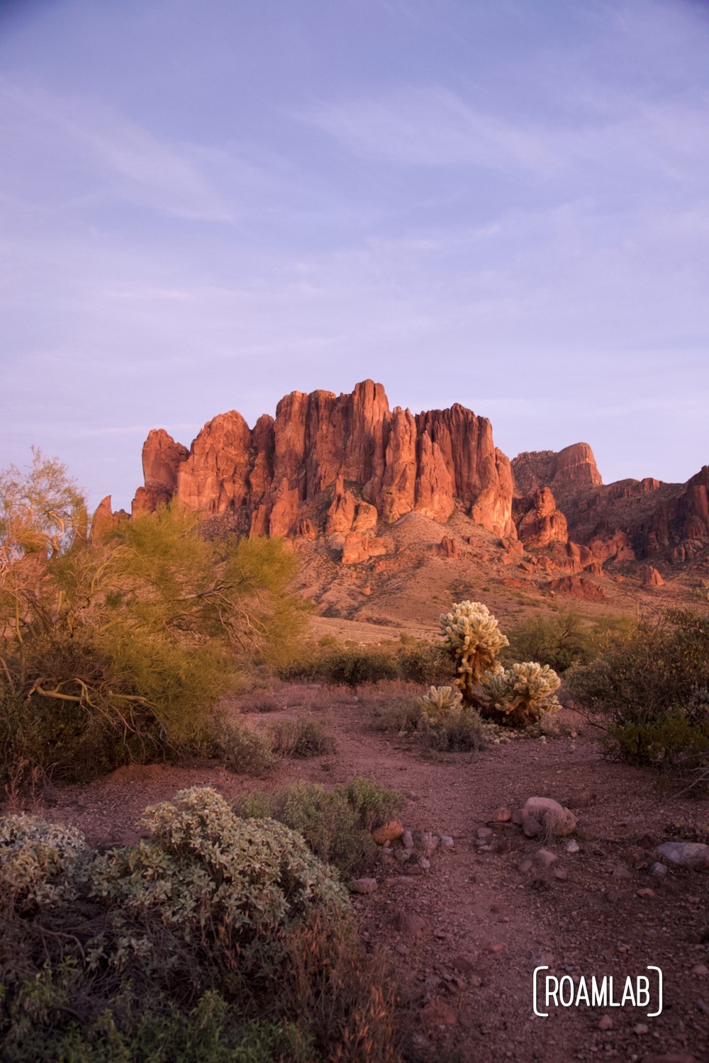 Warm evening light washes the Superstition Mountains in pink at the Lost Dutchman State Park in Arizona.