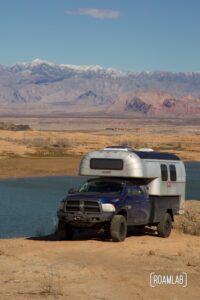 Avion C11 truck camper parked along a cliff by Lake Mead, Nevada.