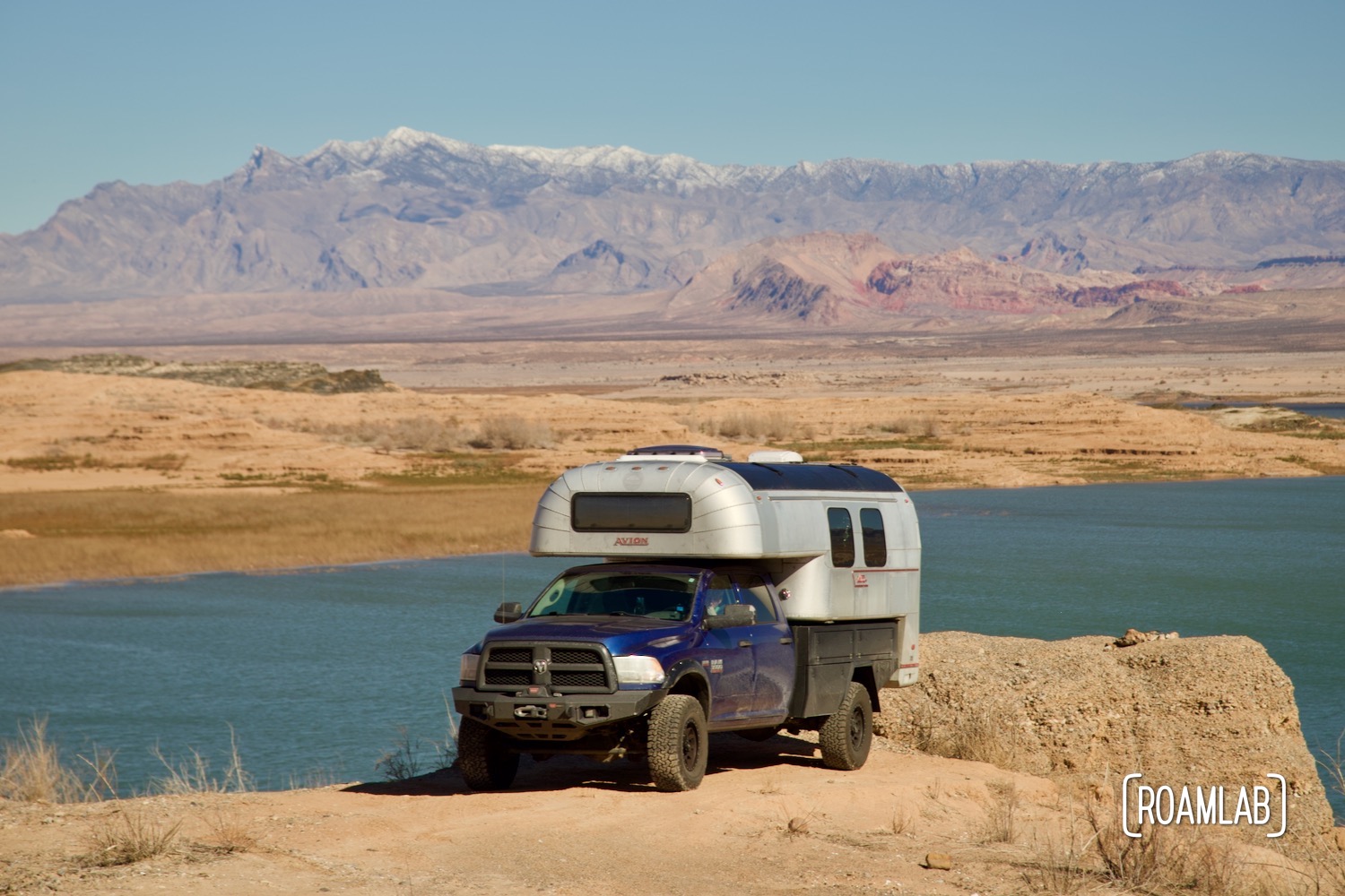 Avion C11 truck camper parked along a cliff by Lake Mead, Nevada.