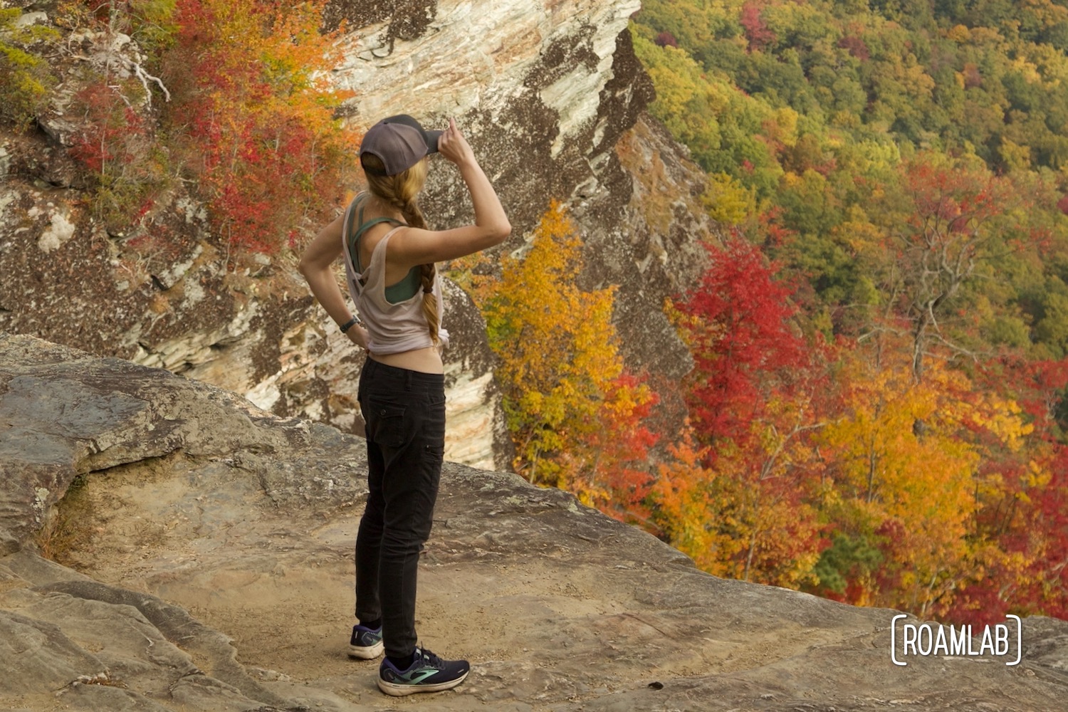 Woman looking out over the fall colors of Linville Gorge Wilderness Area