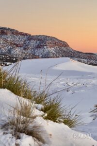 Sunset over the snow covered dunes of Coral Pink Sand Dunes State Park in Northern Arizona.