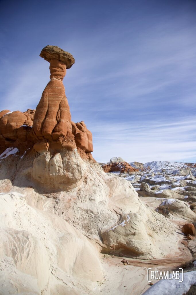 Red sandstone toadstool hoodoo with a brilliant blue sky.