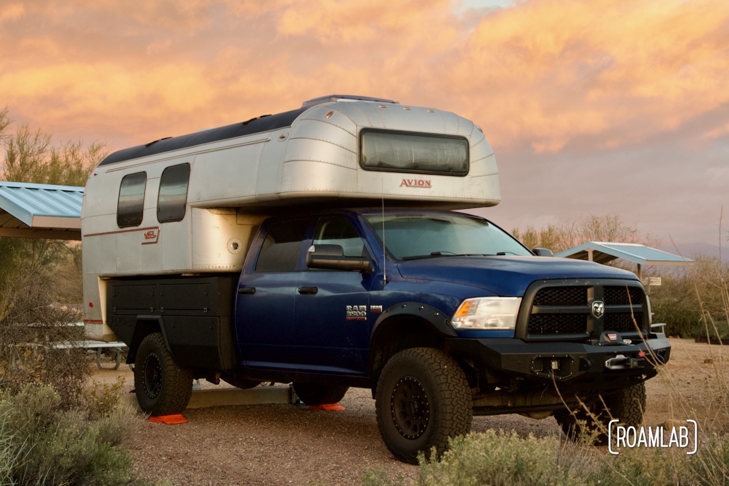 Avion C11 truck camper surrounded by wild sage and pink clouds at sunrise.