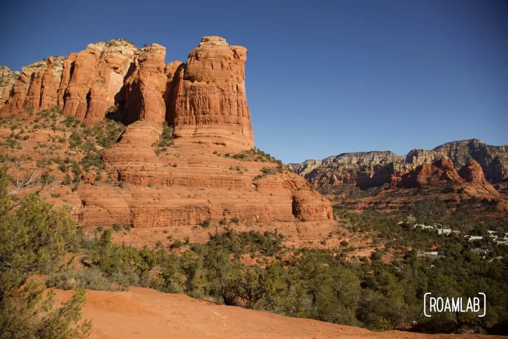 Red rock bluffs rising over green forestland outside Sedona, Arizona in Coconino National Forest.