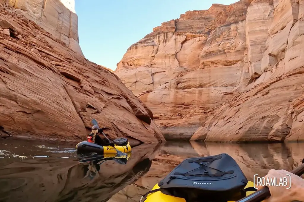 Woman in a yellow rafts paddling through Antelope Canyon off Lake Powell in Northern Arizona.