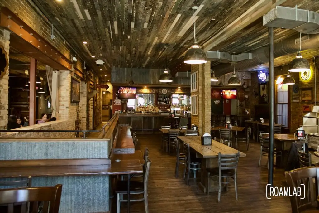 Interior view of a wood walled BBQ restaurant.