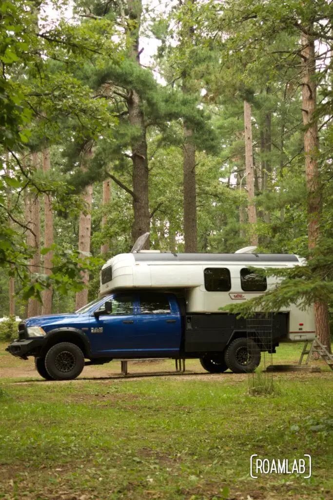 1970 Avion C11 truck camper parked among the woods of Lake Bemidji State Park in northern Minnesota.