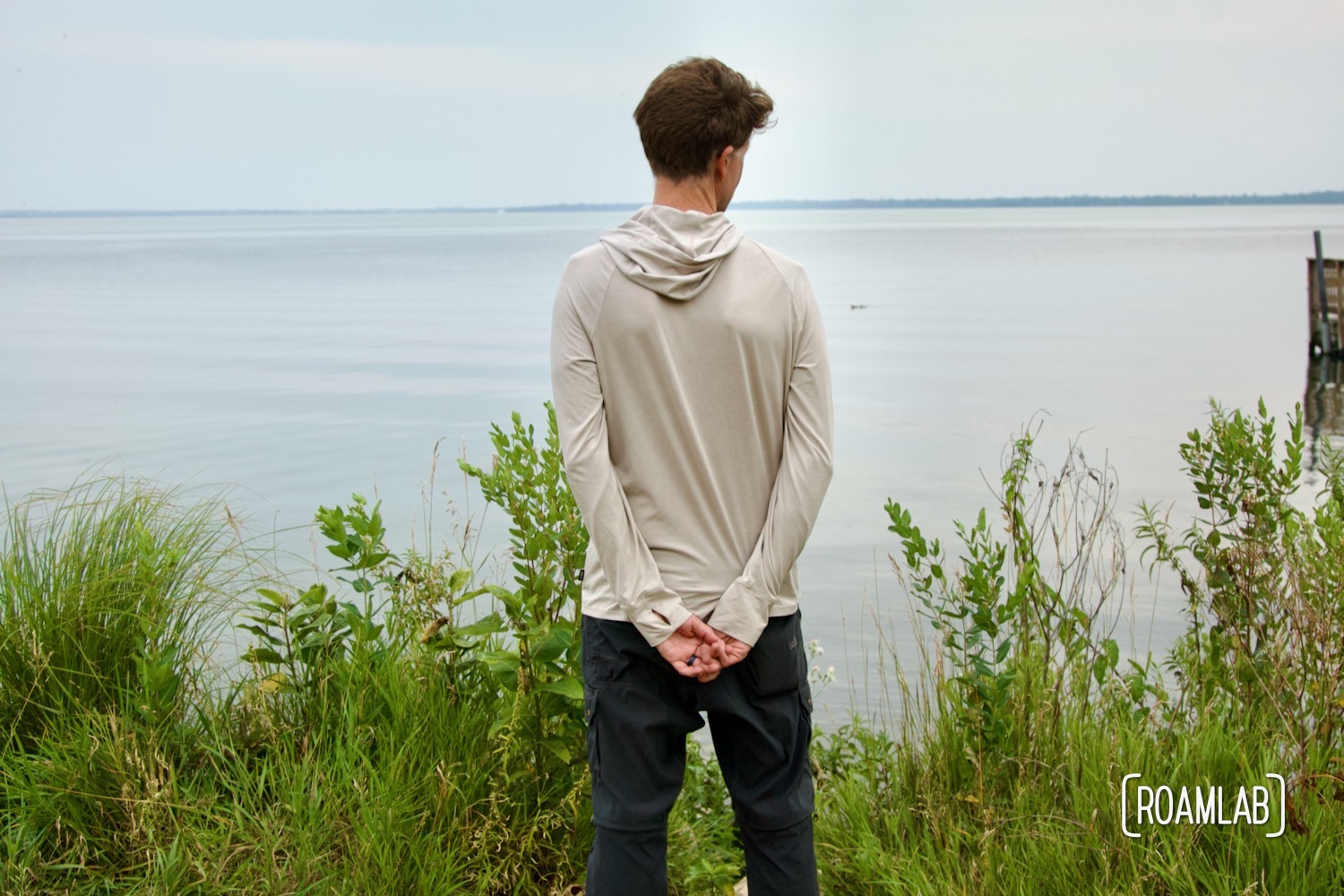 Man looking out over a lake.