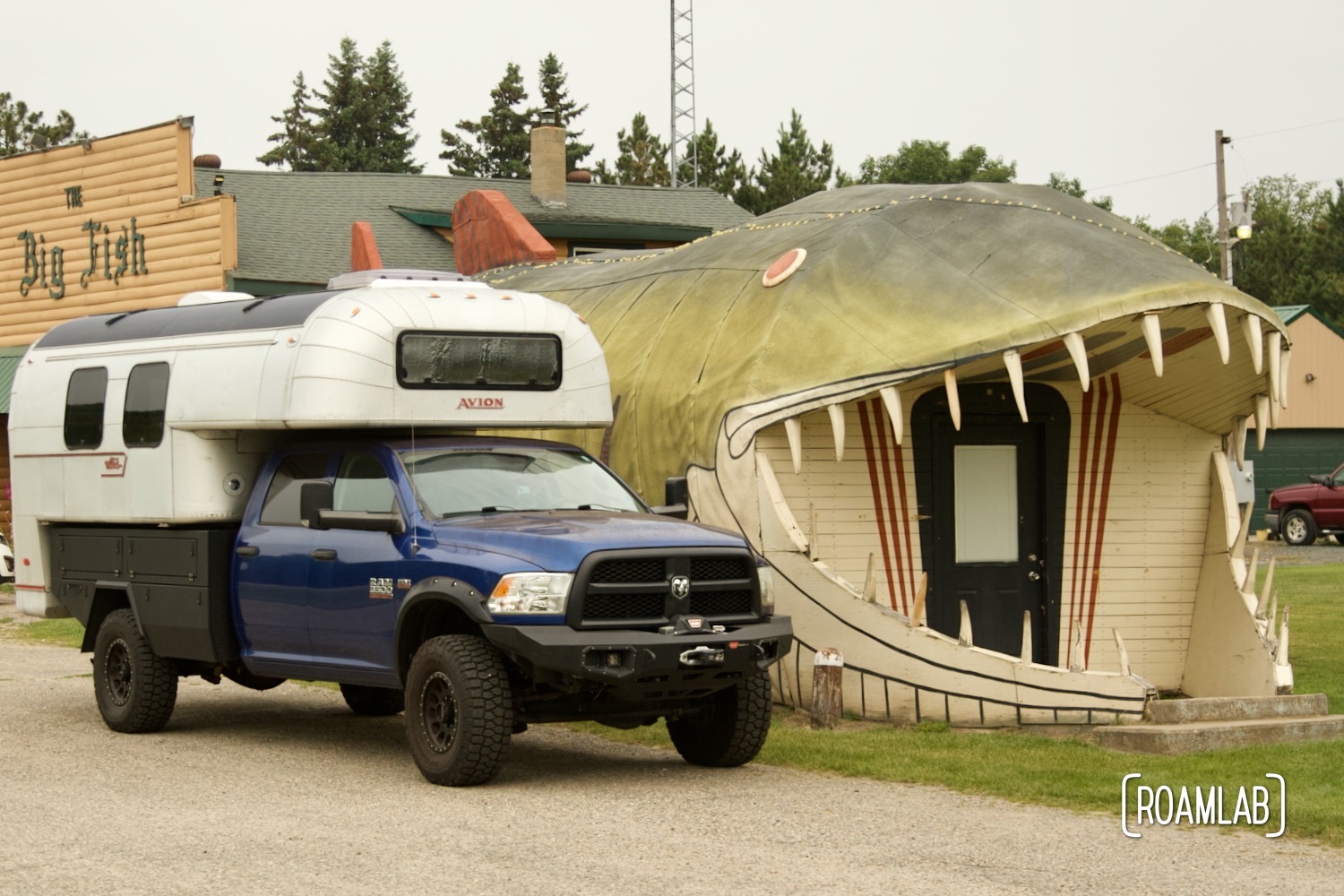 1970 Avion C11 truck camper parked next to a house sized fish in front of a fisherman's super club called The Big Fish off Minnesota’s Great River Road.