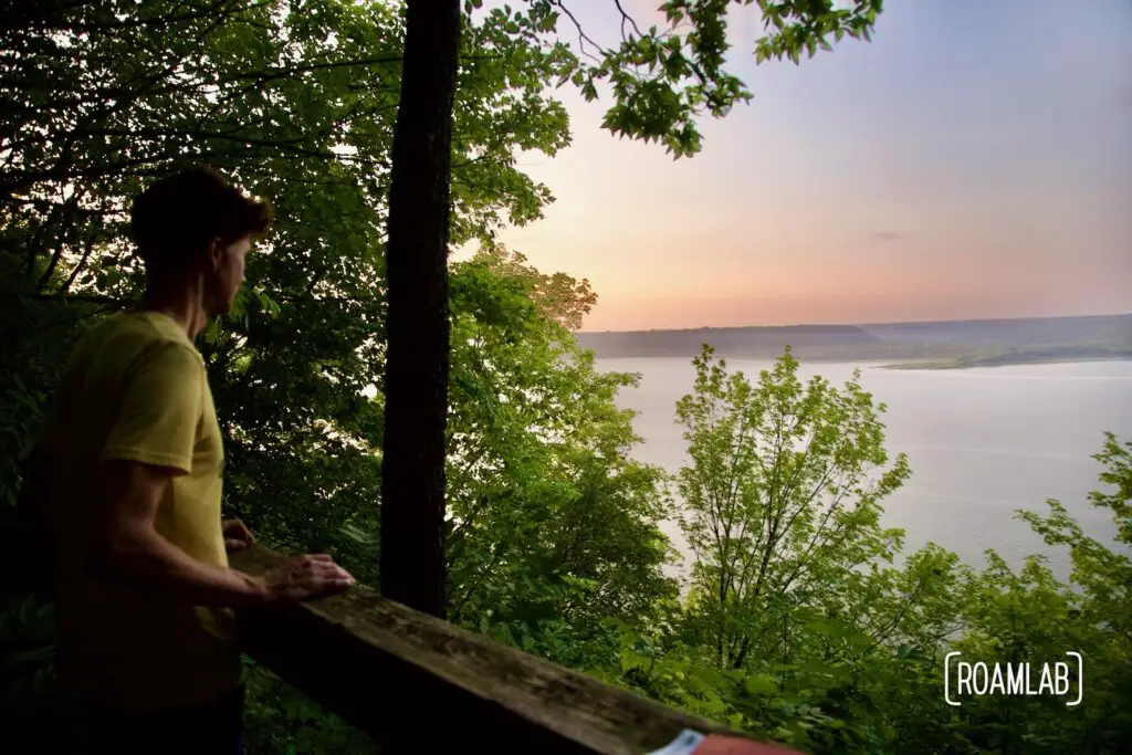 Man standing at an overlook of Lake Pepin at sunset in Fontenac State Park.