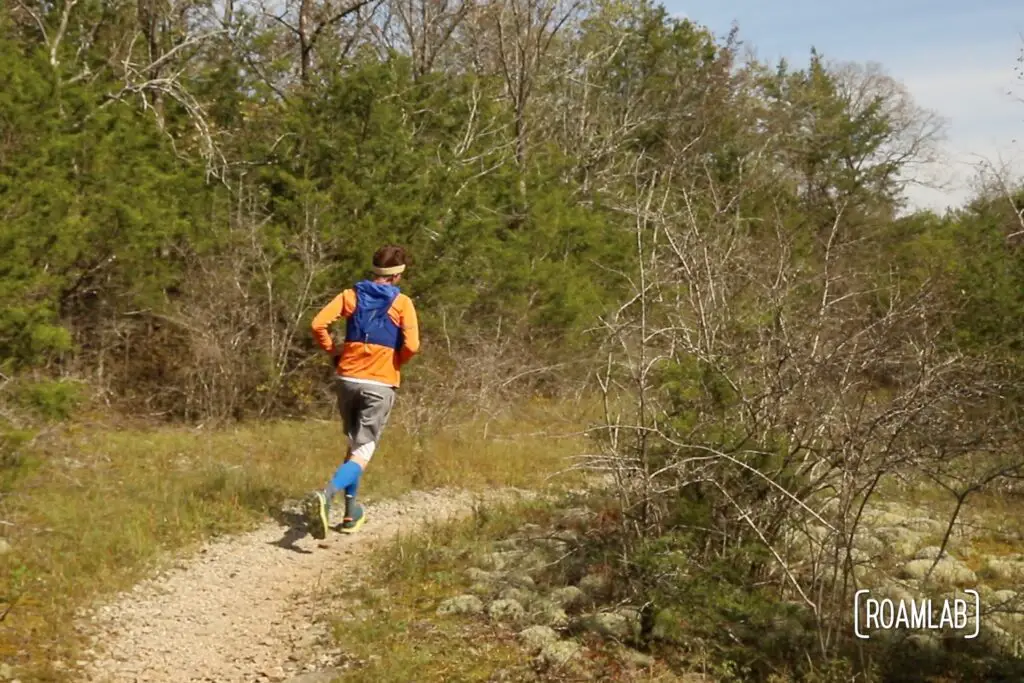 Man running through a grassy clearing.