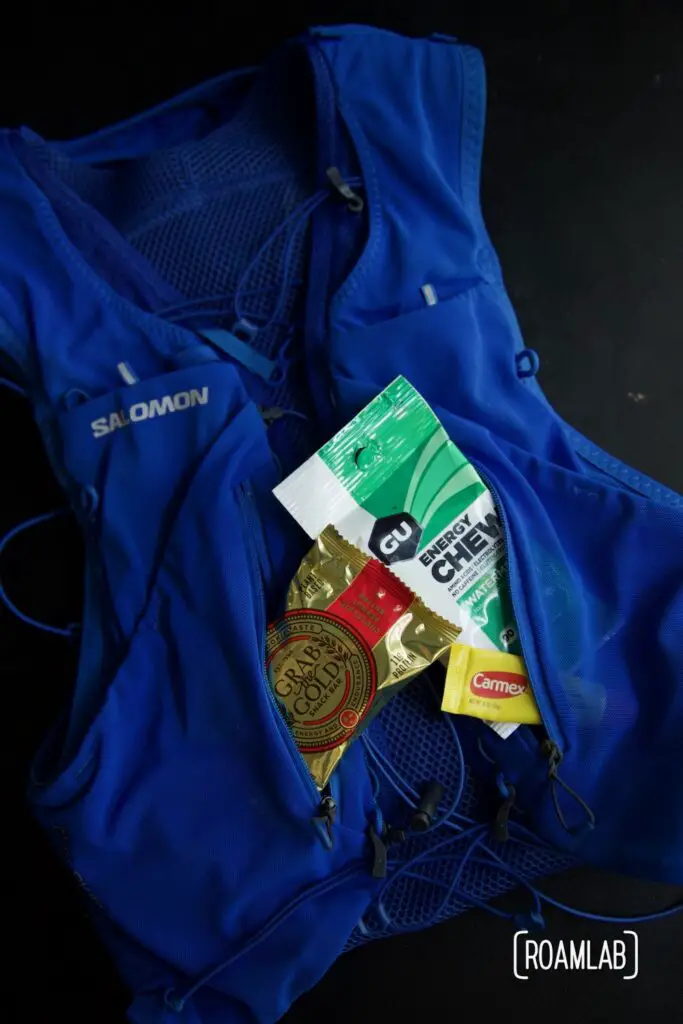Overlay of hydration vest with snacks in the pockets.