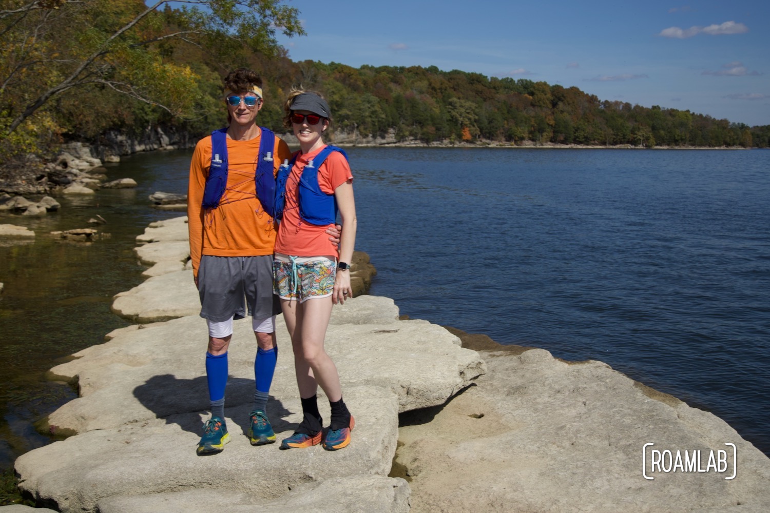 Man and a woman standing on a rock in a lake