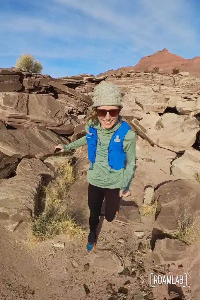 Woman in trail running gear running along Wilderness Loop in Petrified Forest National Park.