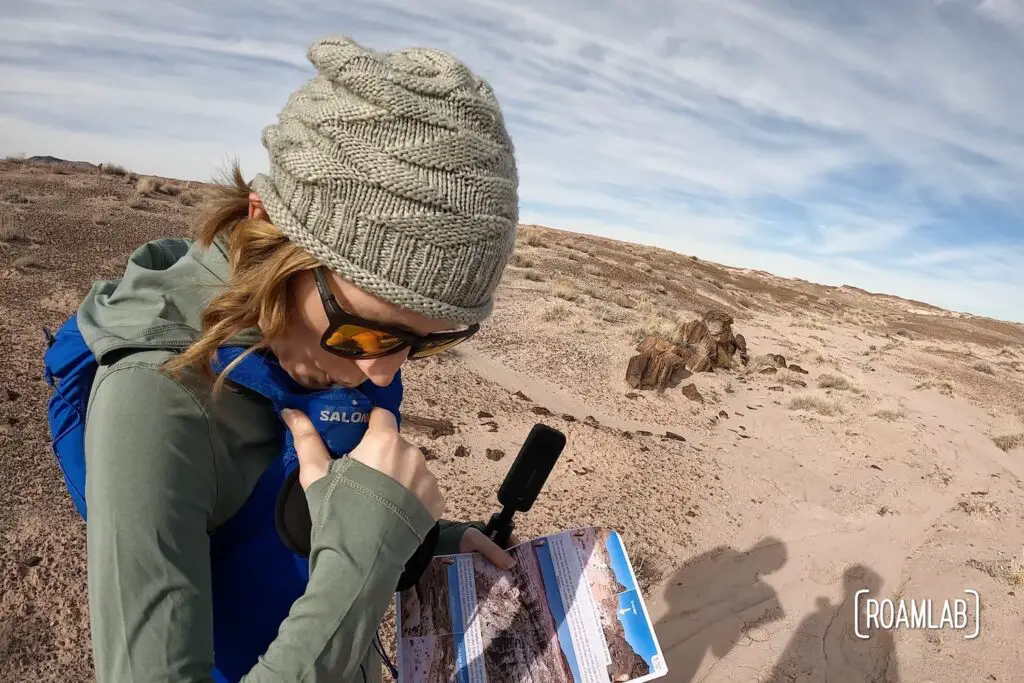 Woman drinking from a hydration pack in the desert.