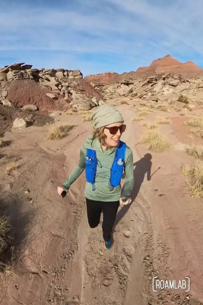 Woman running through the red desert of Wilderness Loop in Petrified Forest National Park