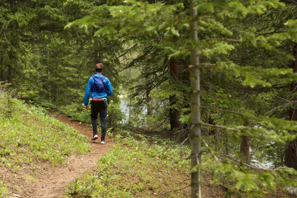 Man running single track trail around Jefferson Lake, Colorado.