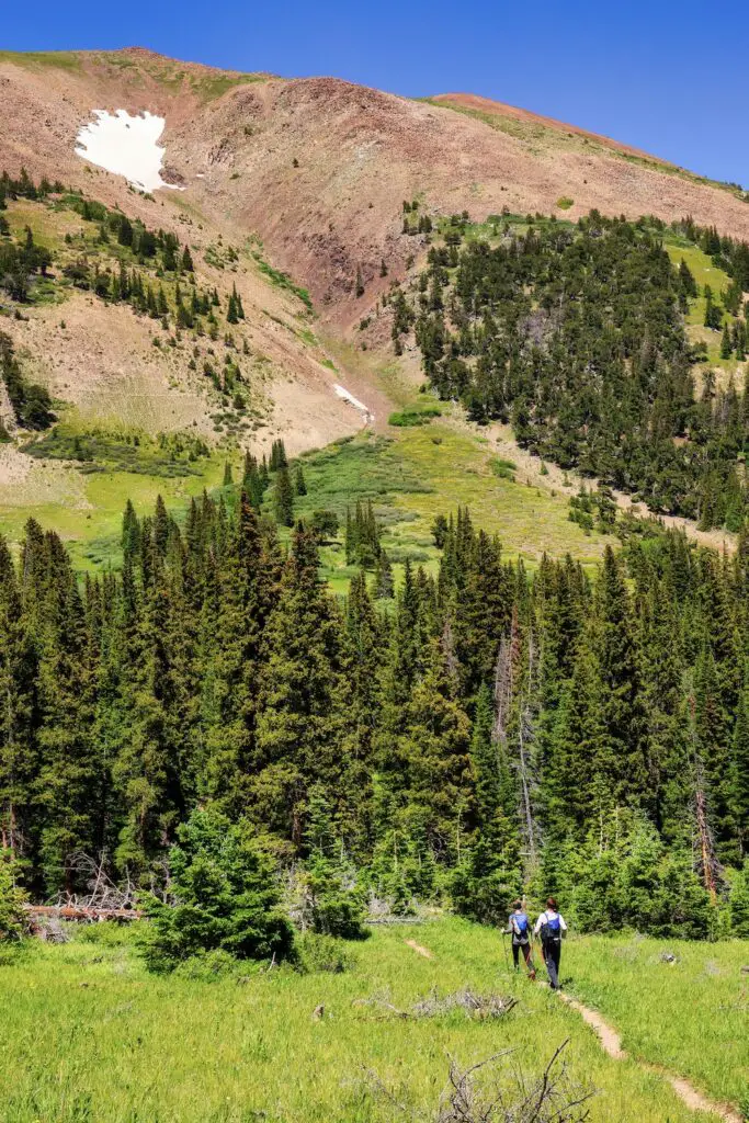 Man and woman running single track trail towards French Pass in the Silverheels 100k.