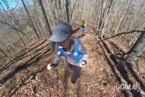 Man and woman racing up a ridge line on the Snaketail 50 marathon trail race.