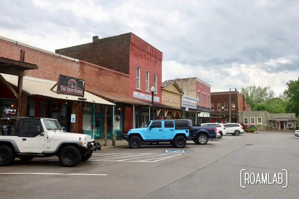 Brick store front with a parking lot full of Jeeps and other 4-wheel drive cars.