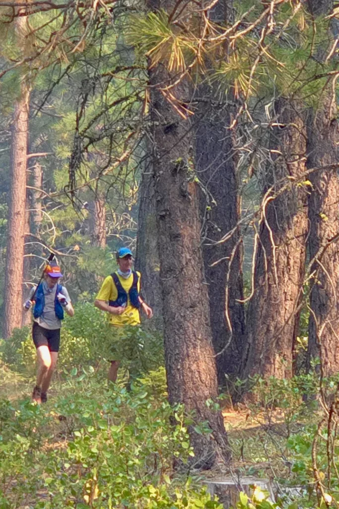 Lexi and Chris running through the woods.