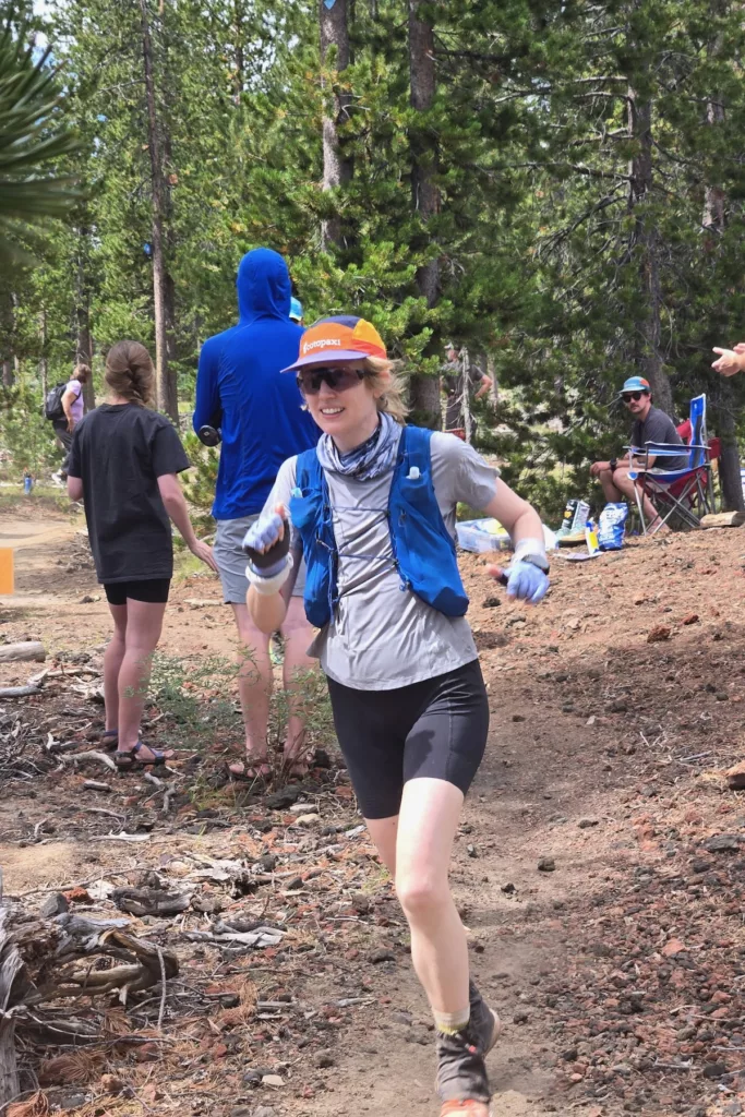 Lexi running into an aid station.