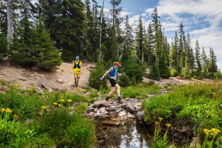 Lexi & Chris crossing a creek along the Oregon Cascades 100 course.