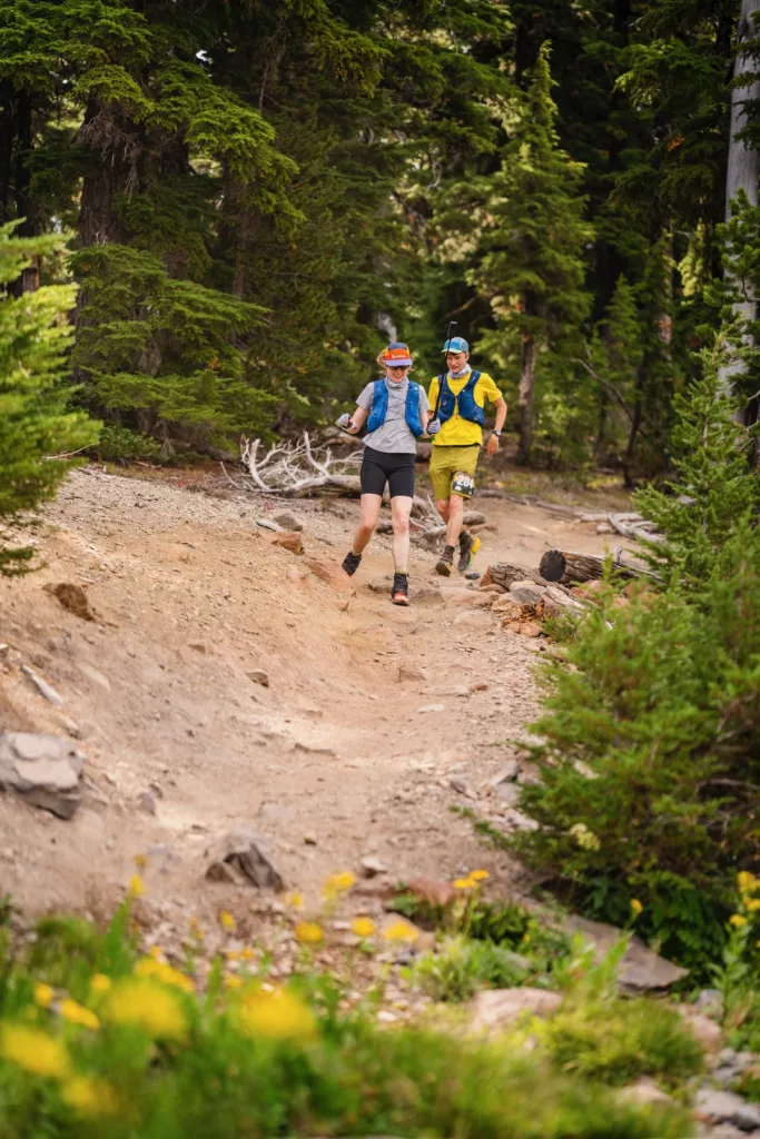 Lexi and Chris running down the dirt course of Oregon Cascades 100.